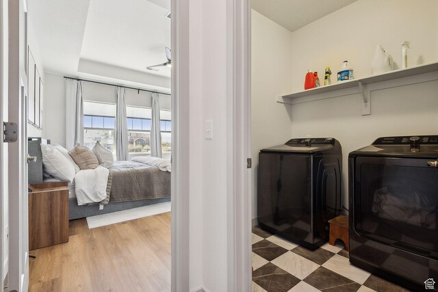 washroom featuring washing machine and dryer, laundry area, and light wood-style flooring