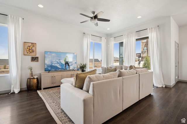 living area featuring dark wood-type flooring, a ceiling fan, baseboards, and recessed lighting