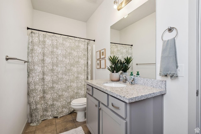 bathroom with tile patterned flooring, toilet, vanity, and curtained shower