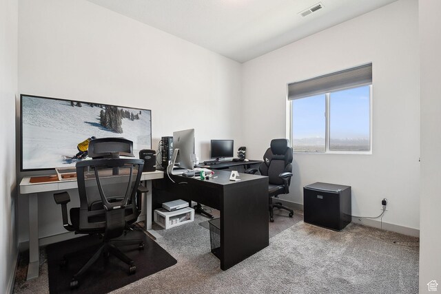 home office with carpet floors, visible vents, and baseboards