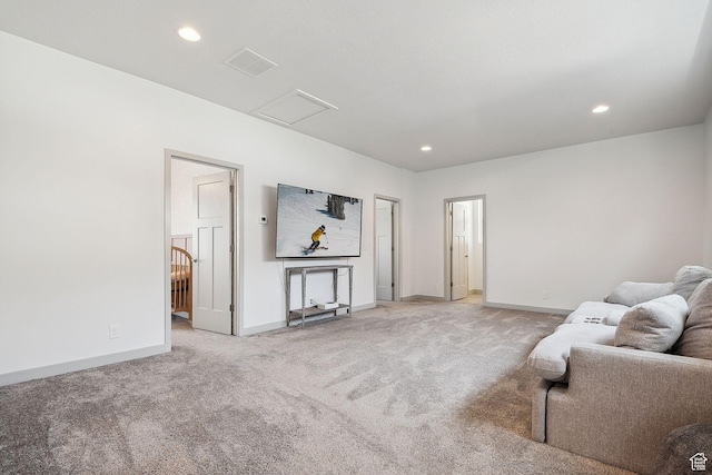 living area with attic access, light carpet, recessed lighting, and baseboards