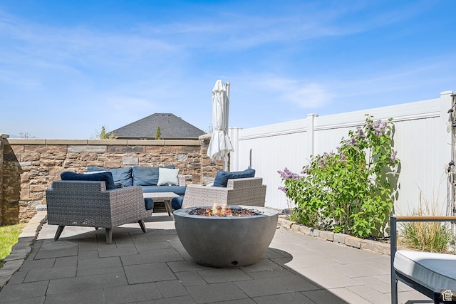 view of patio featuring a fire pit and fence