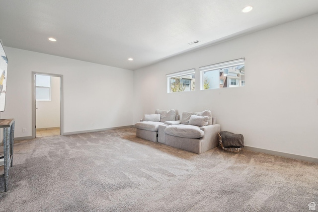 sitting room with recessed lighting, a wealth of natural light, light colored carpet, and visible vents