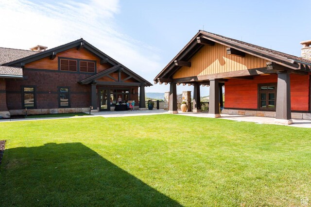 9881 N Uinta Dr, Kamas, UT 84036 - rear view of house with a chimney, a patio area, and a yard