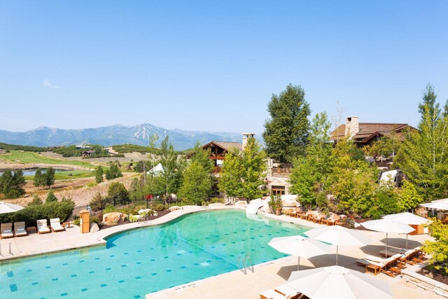 9881 N Uinta Dr, Kamas, UT 84036 - outdoor pool featuring a water slide, a mountain view, and a patio area