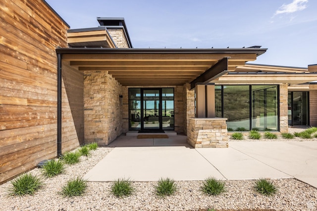 entrance to property featuring stone siding