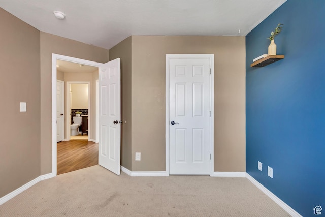 unfurnished bedroom with carpet flooring and baseboards