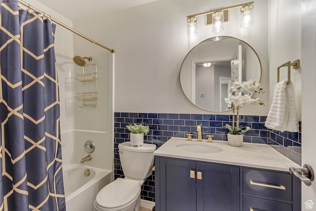 bathroom featuring toilet, wainscoting, tile walls, shower / bath combination with curtain, and vanity