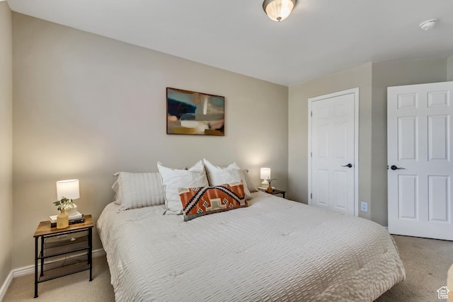 bedroom with baseboards and light carpet