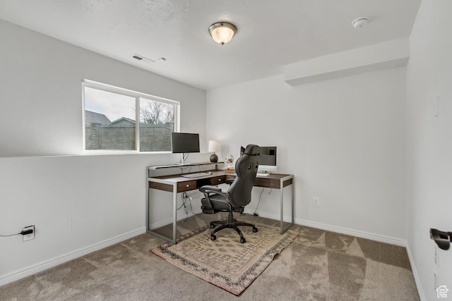 carpeted office space with baseboards and visible vents