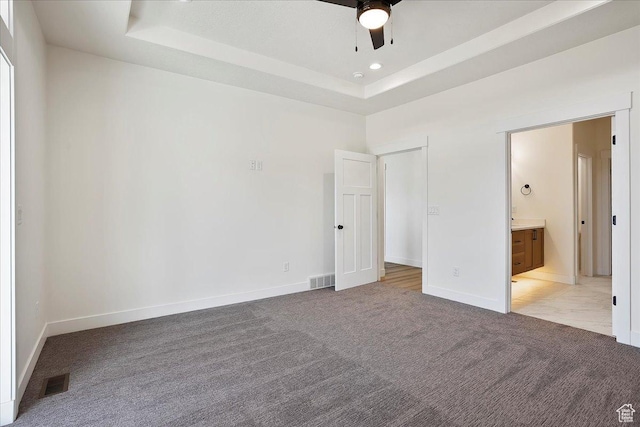 2649 N 3975 W, Plain City, UT 84404 - unfurnished bedroom with connected bathroom, light carpet, a raised ceiling, baseboards, and visible vents