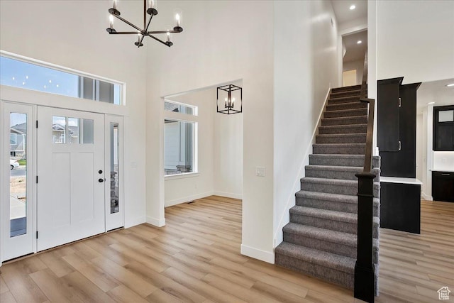 2649 N 3975 W, Plain City, UT 84404 - entrance foyer with stairway, a high ceiling, light wood finished floors, baseboards, and a chandelier