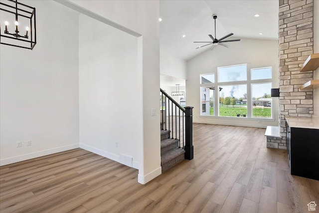 2649 N 3975 W, Plain City, UT 84404 - staircase with ceiling fan with notable chandelier, baseboards, wood finished floors, and high vaulted ceiling