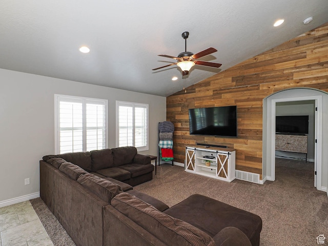 living room featuring recessed lighting, lofted ceiling, wooden walls, baseboards, and ceiling fan
