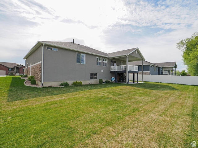 rear view of property featuring fence and a yard