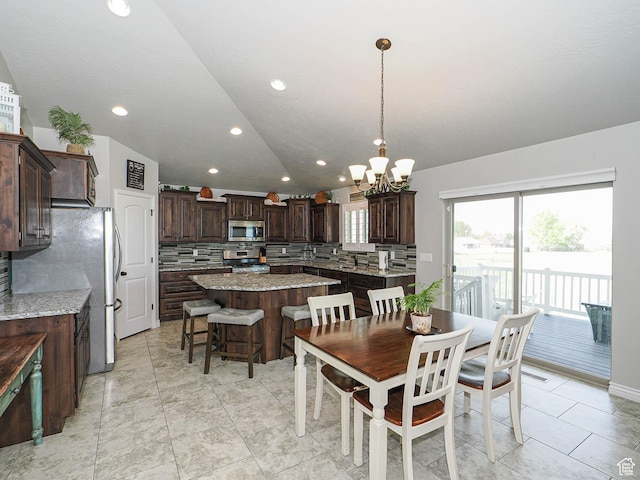 dining area with lofted ceiling, stairs, a chandelier, and recessed lighting