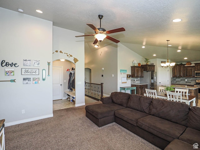 carpeted living room featuring ceiling fan with notable chandelier, arched walkways, baseboards, lofted ceiling, and recessed lighting