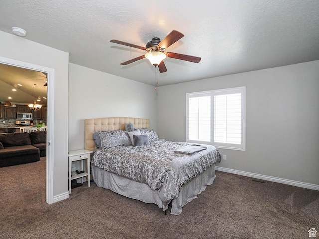 bedroom featuring baseboards, dark colored carpet, visible vents, and ceiling fan with notable chandelier