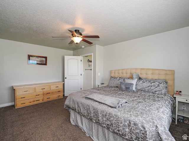 bedroom featuring ceiling fan, carpet floors, and a textured ceiling