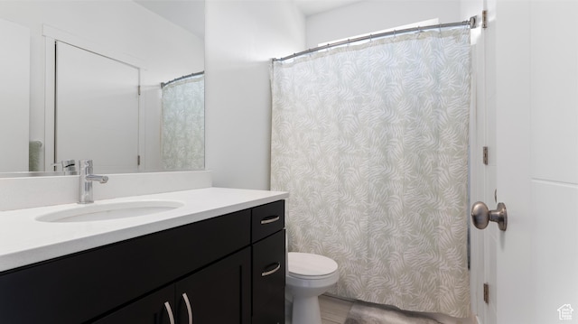 full bathroom featuring wood finished floors, toilet, and vanity