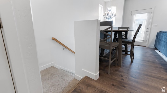 dining space featuring an inviting chandelier, dark wood-style flooring, and baseboards