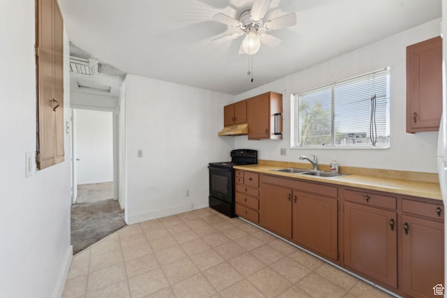 kitchen featuring a sink, under cabinet range hood, black electric range oven, and light countertops