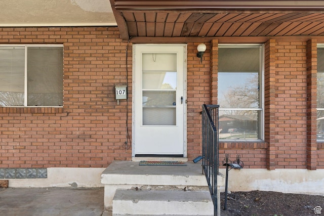 property entrance with brick siding