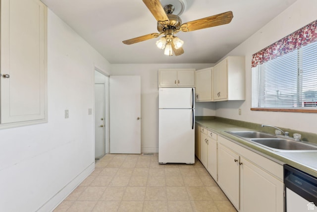 kitchen with a sink, dishwasher, light countertops, freestanding refrigerator, and a ceiling fan