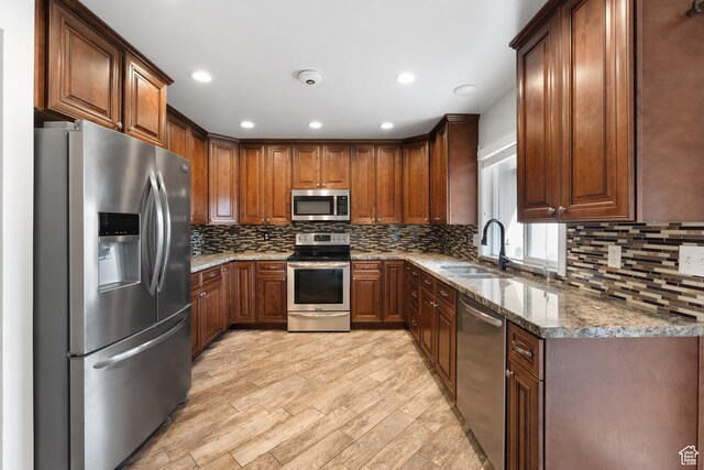 156 E 4635 N, Provo, UT 84604 - kitchen with appliances with stainless steel finishes, tasteful backsplash, a sink, and stone counters