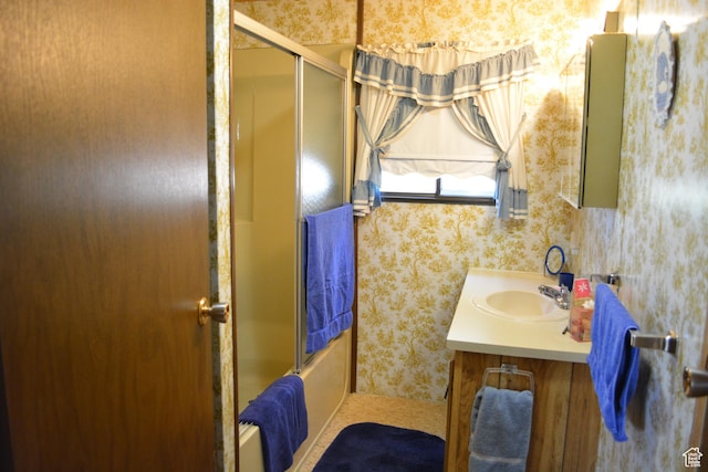 595 N 6th St, Montpelier, ID 83254 - full bathroom with vanity, wallpapered walls, and combined bath / shower with glass door