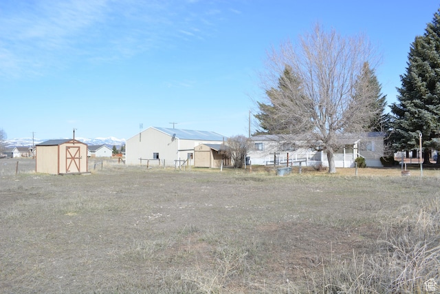 595 N 6th St, Montpelier, ID 83254 - view of yard featuring fence, a storage unit, and an outbuilding