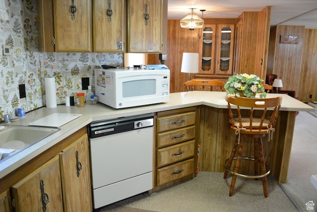 595 N 6th St, Montpelier, ID 83254 - kitchen featuring brown cabinetry, light countertops, and white appliances