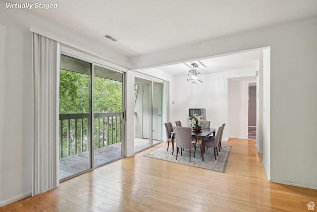 dining space featuring light wood-type flooring and baseboards