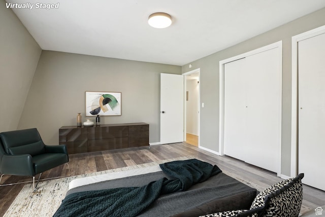 bedroom featuring wood finished floors and baseboards