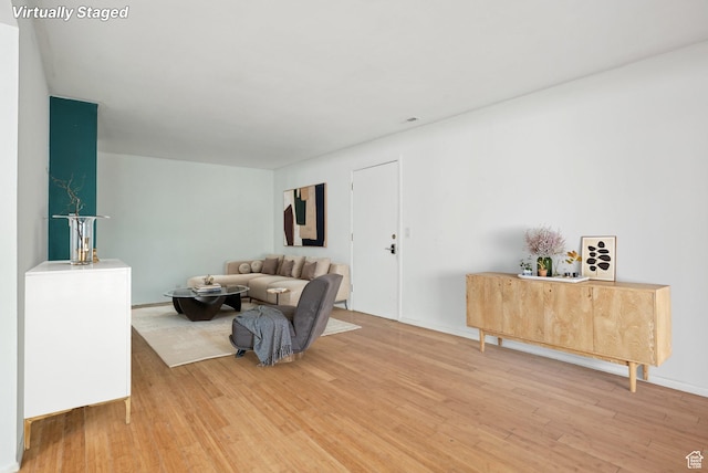 living area with light wood finished floors and baseboards