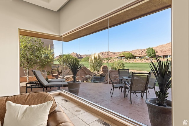2410 W Entrada Trl Unit 15, St George, UT 84770 - sunroom / solarium with a mountain view, visible vents, and a healthy amount of sunlight