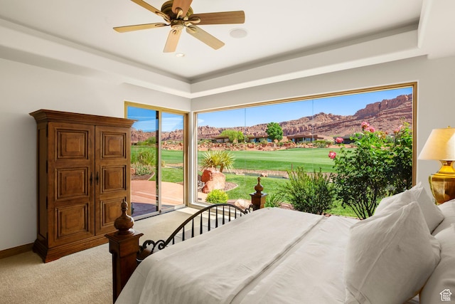 2410 W Entrada Trl Unit 15, St George, UT 84770 - bedroom featuring ceiling fan, light carpet, baseboards, access to outside, and a mountain view