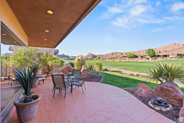2410 W Entrada Trl Unit 15, St George, UT 84770 - view of patio with outdoor dining space and a mountain view