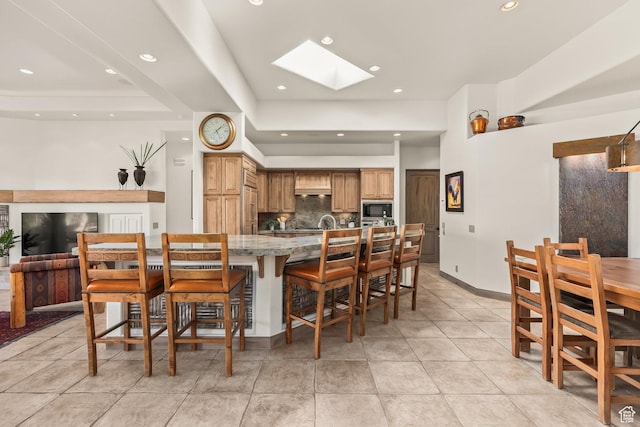 2410 W Entrada Trl Unit 15, St George, UT 84770 - dining room with light tile patterned floors, baseboards, a skylight, and recessed lighting