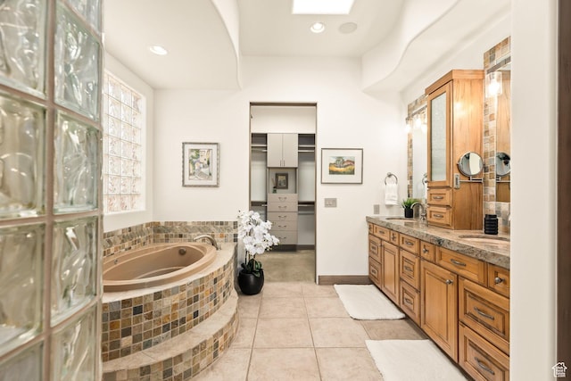 2410 W Entrada Trl Unit 15, St George, UT 84770 - bathroom with a garden tub, a sink, double vanity, tile patterned flooring, and recessed lighting