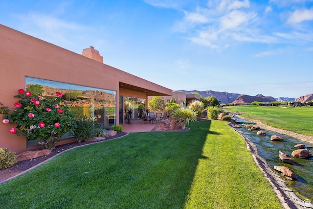 2410 W Entrada Trl Unit 15, St George, UT 84770 - view of yard with a mountain view and a patio