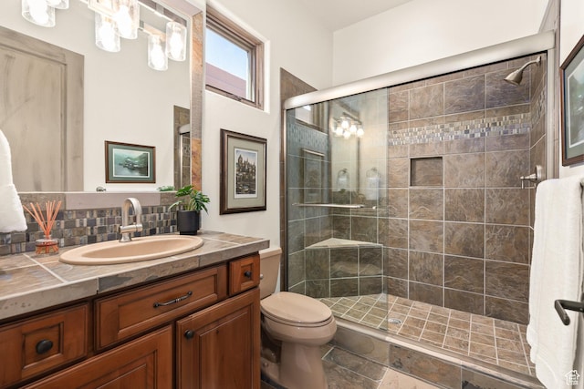 2410 W Entrada Trl Unit 15, St George, UT 84770 - bathroom featuring tasteful backsplash, a shower stall, toilet, and vanity