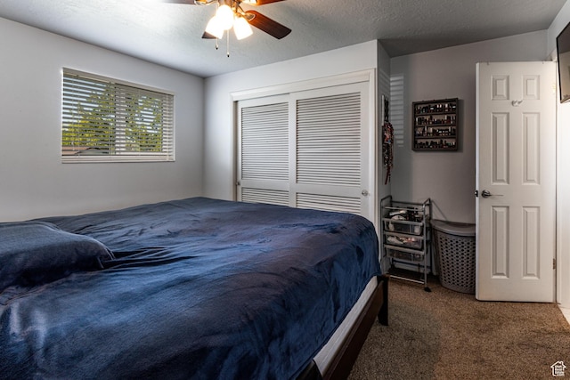 carpeted bedroom with a ceiling fan and a closet