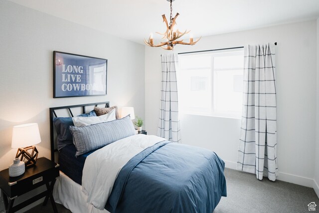 245 E 850 S Unit 149, Spanish Fork, UT 84660 - carpeted bedroom featuring baseboards and a notable chandelier