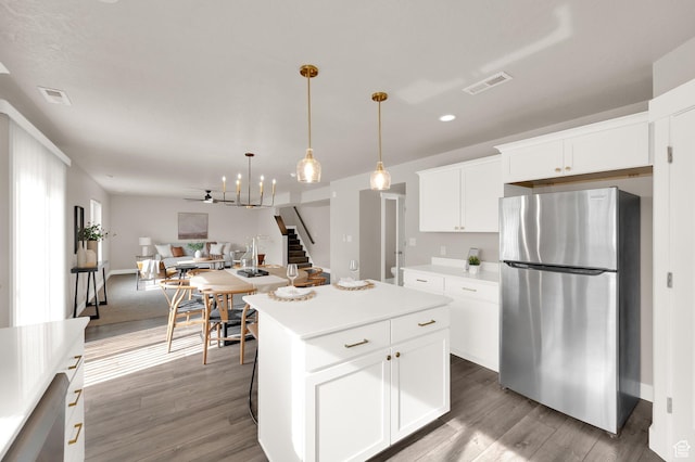 227 N 250 E, Salem, UT 84653 - kitchen featuring visible vents, a kitchen island, light countertops, freestanding refrigerator, and open floor plan