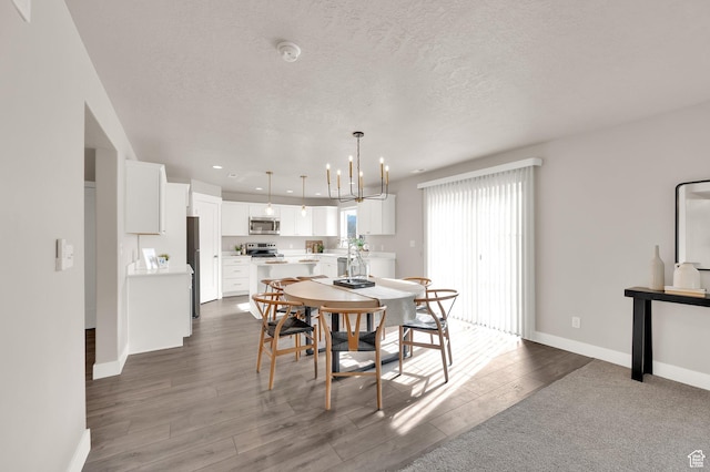 227 N 250 E, Salem, UT 84653 - dining area featuring wood finished floors, a textured ceiling, an inviting chandelier, baseboards, and recessed lighting