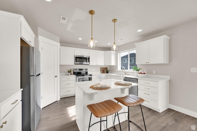 227 N 250 E, Salem, UT 84653 - kitchen featuring a sink, visible vents, recessed lighting, wood finished floors, and appliances with stainless steel finishes