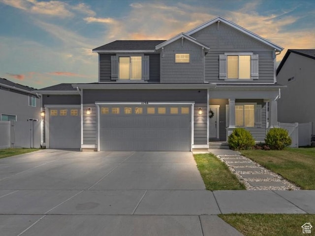 1158 E Bearing Dr S, Saratoga Springs, UT 84045 - view of front of property featuring an attached garage, fence, covered porch, and concrete driveway