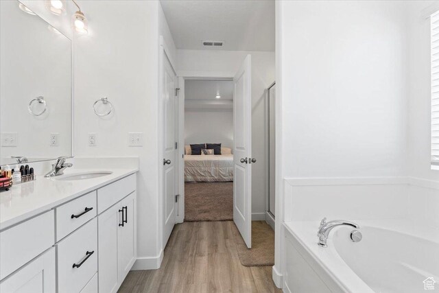 1158 E Bearing Dr S, Saratoga Springs, UT 84045 - full bath featuring a bath, ensuite bath, visible vents, wood finished floors, and vanity
