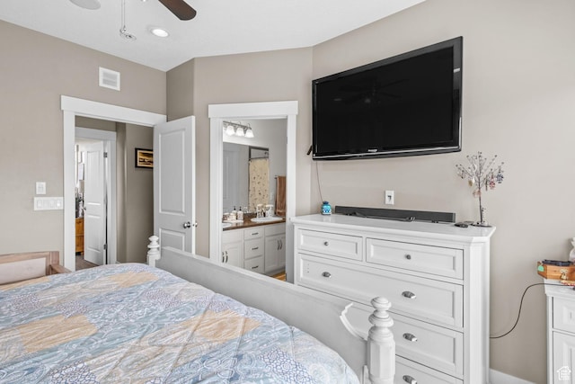 bedroom with connected bathroom, a ceiling fan, a sink, and visible vents
